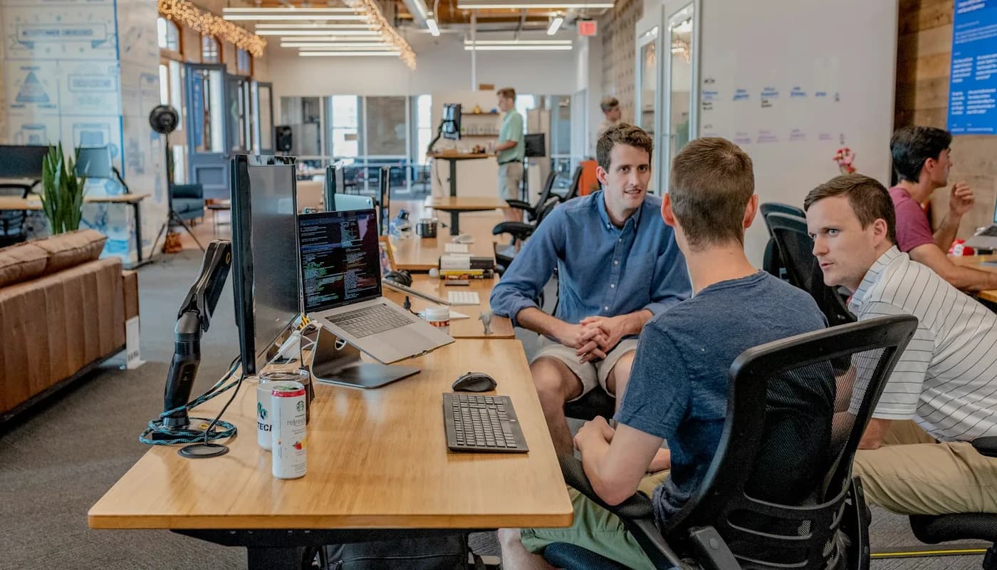 Two colleagues discussing product options together at a laptop