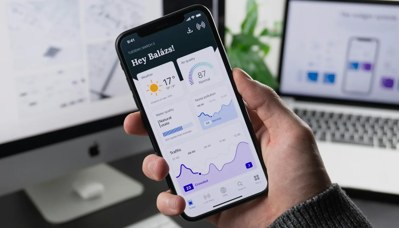 Smartphones showing real mobile app interfaces on a desk